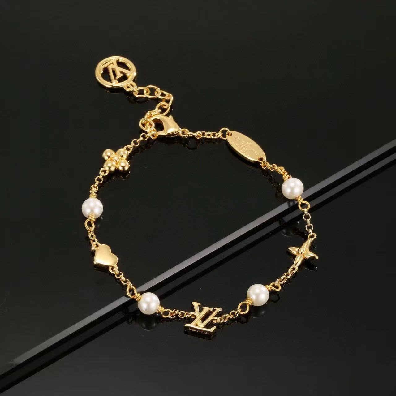 Louis Vuitton Gold Tone Bracelet with Pearls and Charms Louis Vuitton Gold Tone Bracelet with Pearls and Charms